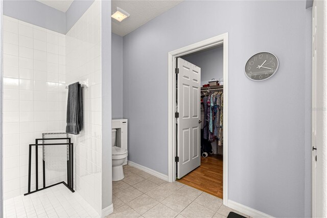 9551 SW 92nd Ter, Ocala, FL 34481 - bathroom with toilet, tile patterned flooring, a walk in closet, and baseboards