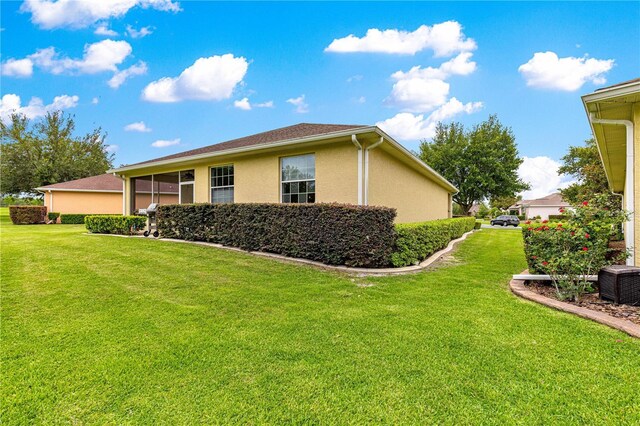 9551 SW 92nd Ter, Ocala, FL 34481 - view of side of property featuring a lawn and stucco siding