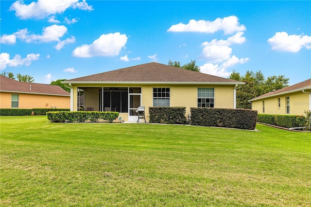 9551 SW 92nd Ter, Ocala, FL 34481 - rear view of property featuring a lawn, a sunroom, and stucco siding