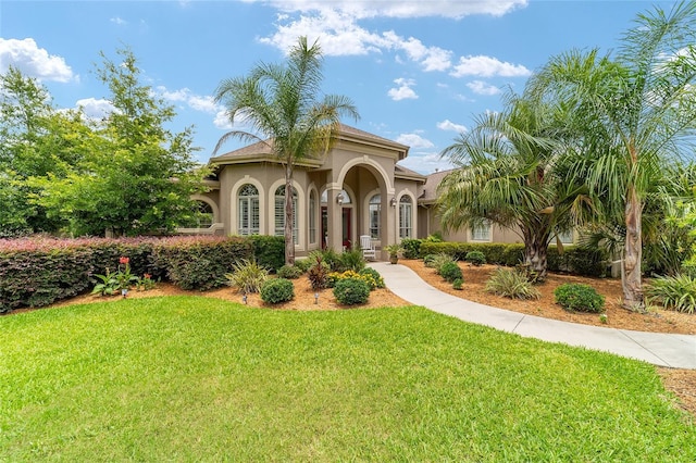 3986 SE 43rd Cir, Ocala, FL 34480 - mediterranean / spanish house with stucco siding and a front yard