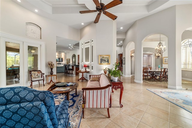 3986 SE 43rd Cir, Ocala, FL 34480 - living room with arched walkways, recessed lighting, a high ceiling, a chandelier, and a ceiling fan
