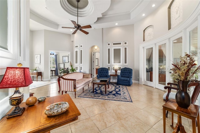 3986 SE 43rd Cir, Ocala, FL 34480 - tiled living room featuring a towering ceiling, recessed lighting, arched walkways, french doors, and a tray ceiling