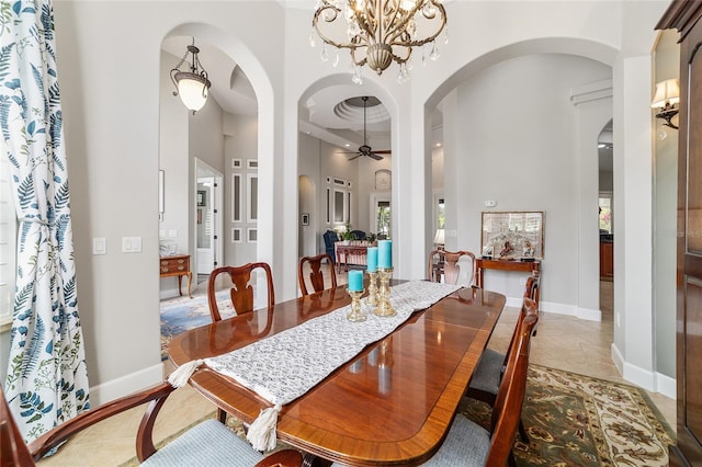 3986 SE 43rd Cir, Ocala, FL 34480 - dining area featuring a high ceiling, a ceiling fan, arched walkways, a chandelier, and healthy amount of natural light