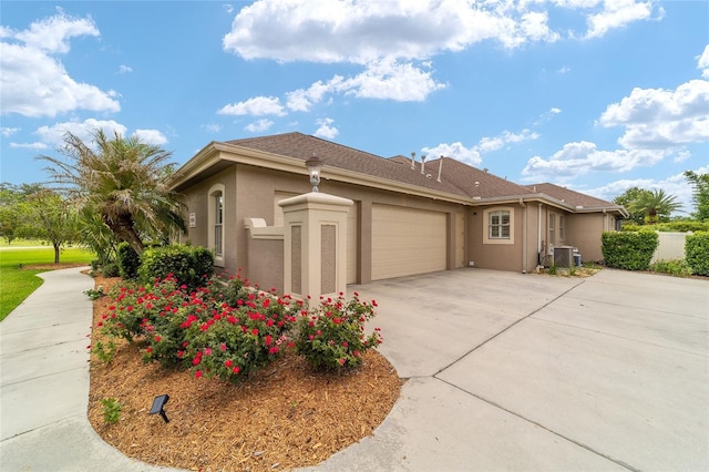 3986 SE 43rd Cir, Ocala, FL 34480 - view of side of property featuring a garage, stucco siding, and driveway