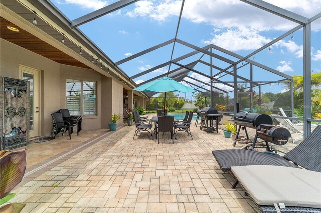 3986 SE 43rd Cir, Ocala, FL 34480 - view of patio featuring glass enclosure, an outdoor pool, grilling area, and outdoor dining space