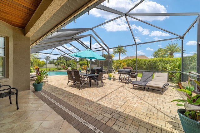3986 SE 43rd Cir, Ocala, FL 34480 - view of patio / terrace featuring glass enclosure, outdoor dining space, and grilling area