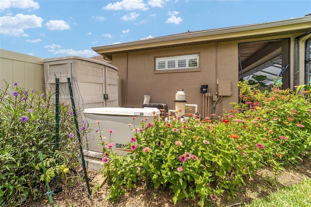 3986 SE 43rd Cir, Ocala, FL 34480 - view of side of home with stucco siding and a storage unit