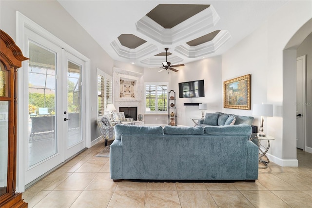 3986 SE 43rd Cir, Ocala, FL 34480 - living area featuring arched walkways, light tile patterned floors, a fireplace, ceiling fan, and coffered ceiling