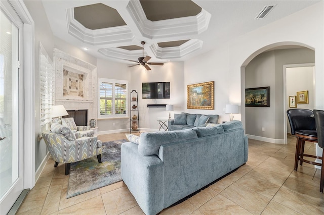 3986 SE 43rd Cir, Ocala, FL 34480 - living room with arched walkways, a ceiling fan, crown molding, coffered ceiling, and light tile patterned flooring