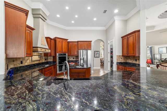 3986 SE 43rd Cir, Ocala, FL 34480 - kitchen with stainless steel appliances, arched walkways, decorative backsplash, recessed lighting, and ornamental molding