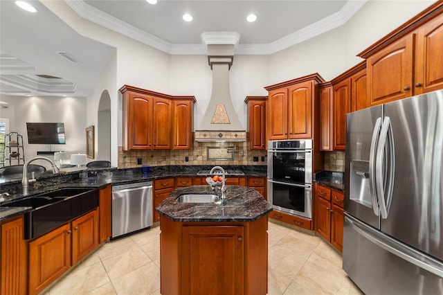 3986 SE 43rd Cir, Ocala, FL 34480 - kitchen featuring appliances with stainless steel finishes, arched walkways, dark stone countertops, backsplash, and crown molding