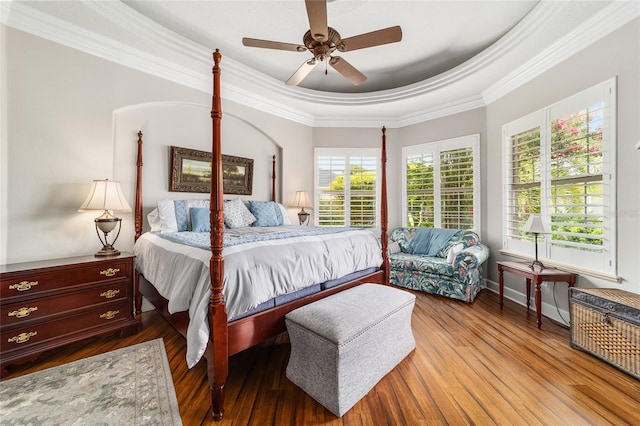 3986 SE 43rd Cir, Ocala, FL 34480 - bedroom featuring a tray ceiling, wood finished floors, ornamental molding, and ceiling fan