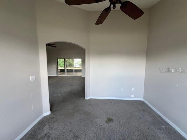 8100 SW 56th Ter, Ocala, FL 34476 - unfurnished room with carpet floors, arched walkways, a ceiling fan, baseboards, and a high ceiling