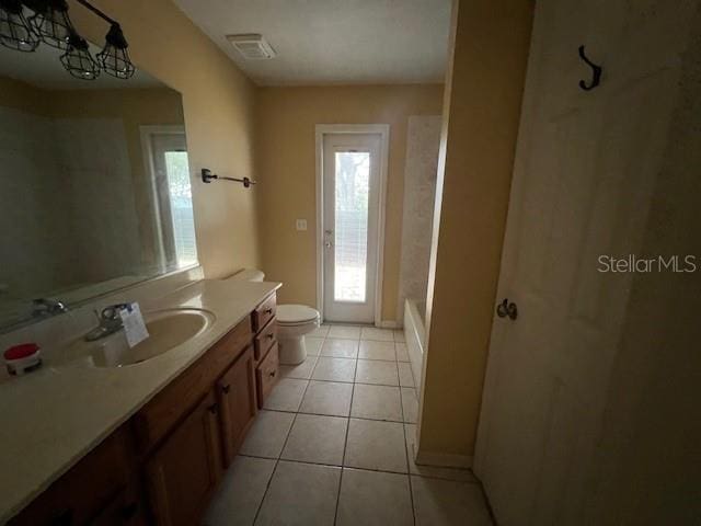 8100 SW 56th Ter, Ocala, FL 34476 - bathroom featuring vanity, toilet, healthy amount of natural light, and tile patterned floors