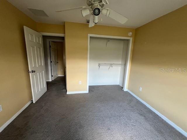 8100 SW 56th Ter, Ocala, FL 34476 - unfurnished bedroom featuring baseboards, dark carpet, a closet, and a ceiling fan
