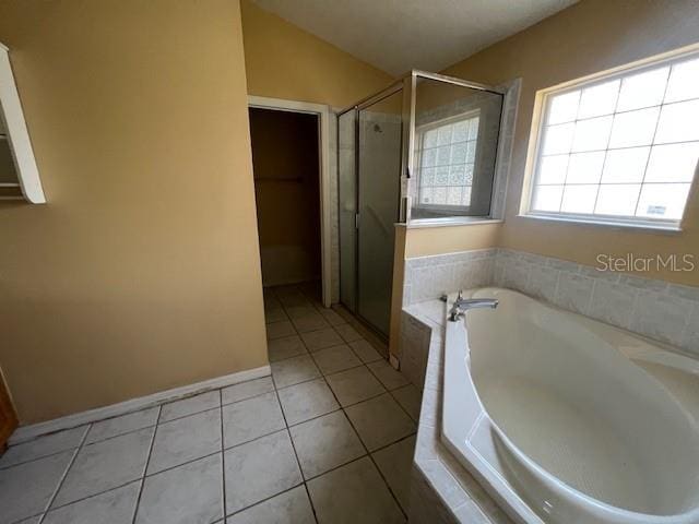 8100 SW 56th Ter, Ocala, FL 34476 - full bathroom featuring a stall shower, a garden tub, tile patterned flooring, and vaulted ceiling