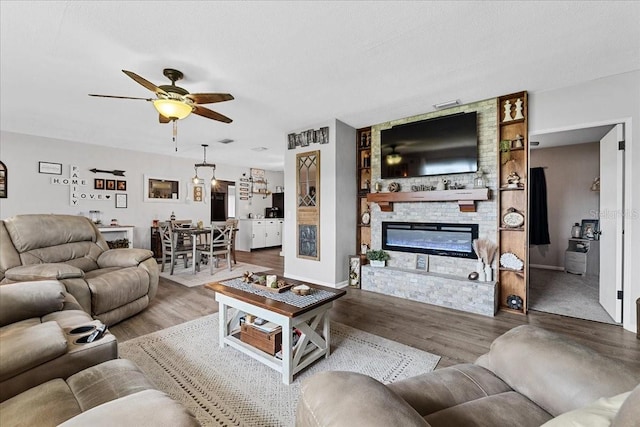 460 E Haines Blvd, Lake Alfred, FL 33850 - living room featuring ceiling fan, wood finished floors, and a large fireplace