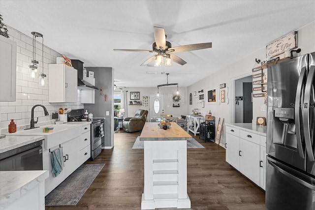 460 E Haines Blvd, Lake Alfred, FL 33850 - kitchen with stainless steel appliances, wall chimney range hood, a ceiling fan, hanging light fixtures, and a center island