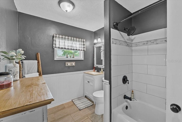460 E Haines Blvd, Lake Alfred, FL 33850 - bathroom with vanity, toilet, shower / tub combination, wainscoting, and a textured ceiling