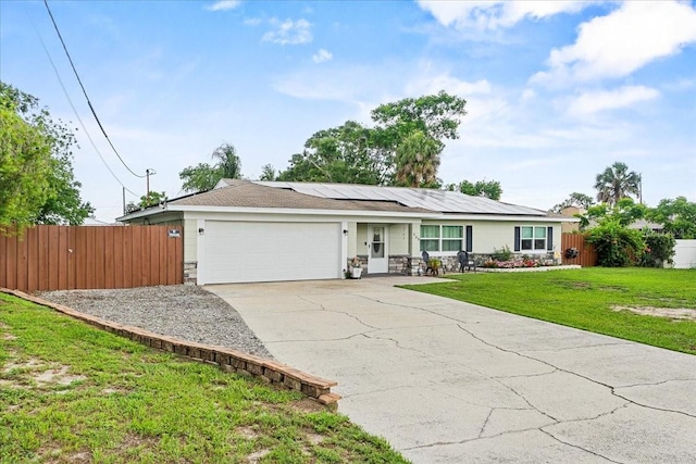 460 E Haines Blvd, Lake Alfred, FL 33850 - single story home with stone siding, a garage, solar panels, and driveway