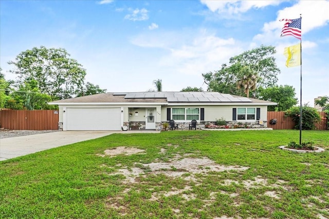 460 E Haines Blvd, Lake Alfred, FL 33850 - ranch-style house featuring concrete driveway, an attached garage, solar panels, and stone siding