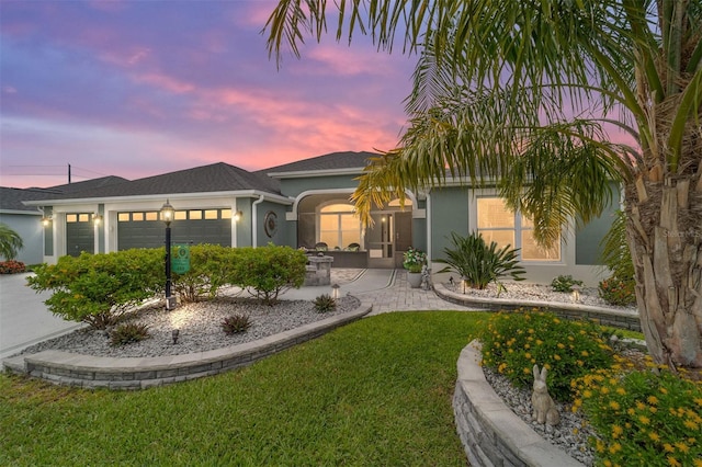 488 Seth Run, The Villages, FL 32163 - ranch-style house with stucco siding, a garage, a yard, and concrete driveway