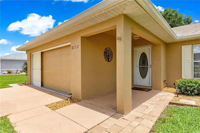 8732 SW 60th Cir, Ocala, FL 34476 - doorway to property with stucco siding and concrete driveway