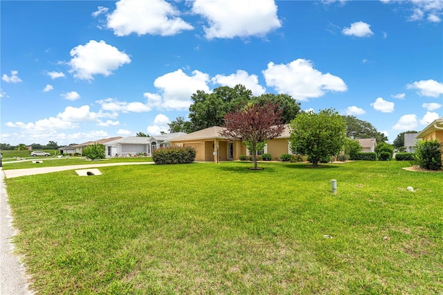 8732 SW 60th Cir, Ocala, FL 34476 - view of front of property with concrete driveway, a garage, a front yard, and stucco siding