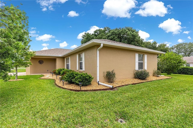 8732 SW 60th Cir, Ocala, FL 34476 - view of side of home featuring stucco siding and a yard