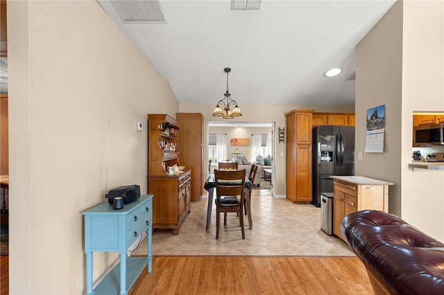 8732 SW 60th Cir, Ocala, FL 34476 - dining room with a chandelier, vaulted ceiling, light tile patterned flooring, recessed lighting, and a textured ceiling