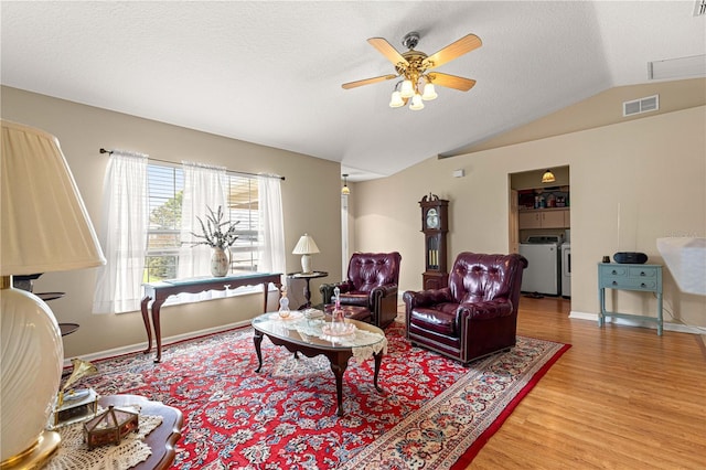 8732 SW 60th Cir, Ocala, FL 34476 - living area with washer and dryer, wood finished floors, a ceiling fan, lofted ceiling, and baseboards