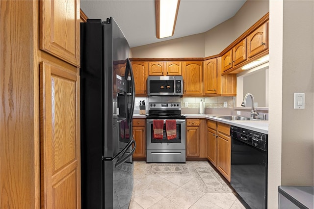 8732 SW 60th Cir, Ocala, FL 34476 - kitchen with black appliances, a sink, vaulted ceiling, light tile patterned floors, and decorative backsplash