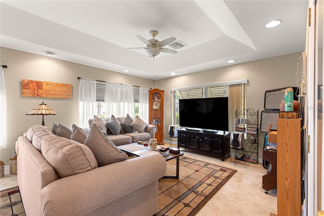 8732 SW 60th Cir, Ocala, FL 34476 - living room with ceiling fan, a raised ceiling, recessed lighting, light tile patterned floors, and baseboards
