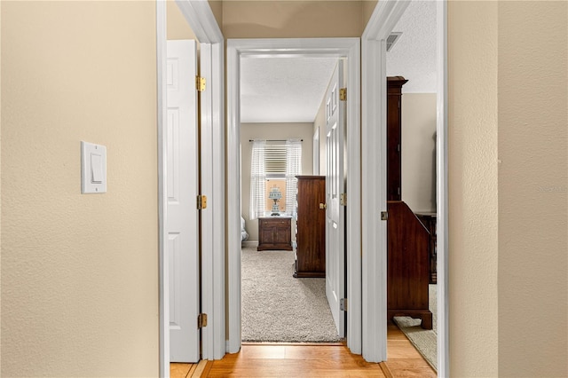 8732 SW 60th Cir, Ocala, FL 34476 - hall featuring light wood-style floors and a textured wall