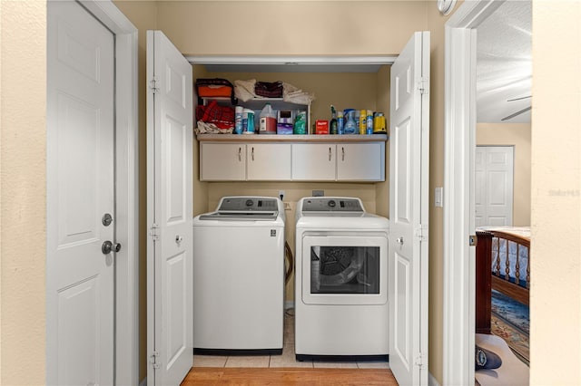 8732 SW 60th Cir, Ocala, FL 34476 - laundry room with washer and clothes dryer, cabinet space, and light tile patterned floors