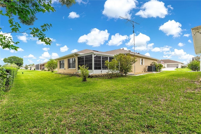 8732 SW 60th Cir, Ocala, FL 34476 - rear view of property featuring central air condition unit, a sunroom, and a lawn