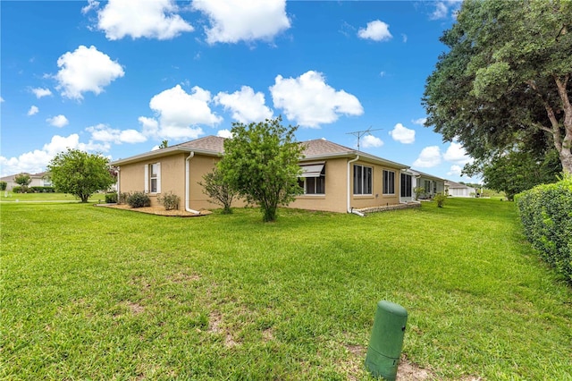 8732 SW 60th Cir, Ocala, FL 34476 - back of house featuring a lawn and stucco siding