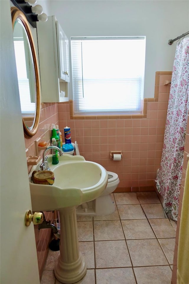 2810 SE Lake Weir Ave, Ocala, FL 34471 - bathroom with tile walls, tile patterned floors, plenty of natural light, curtained shower, and toilet