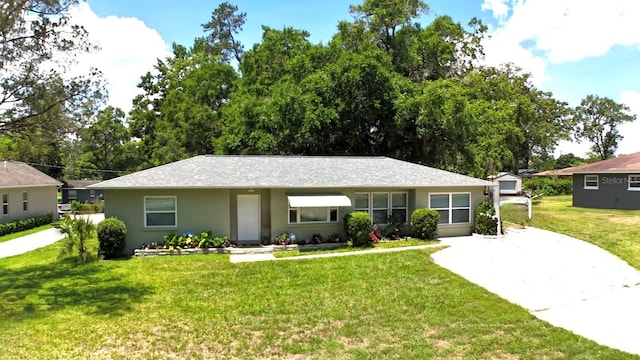 2810 SE Lake Weir Ave, Ocala, FL 34471 - view of front facade with driveway, a front yard, and stucco siding