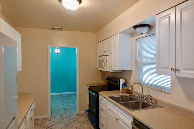 2810 SE Lake Weir Ave, Ocala, FL 34471 - kitchen featuring range with electric stovetop, a sink, white microwave, and white cabinetry