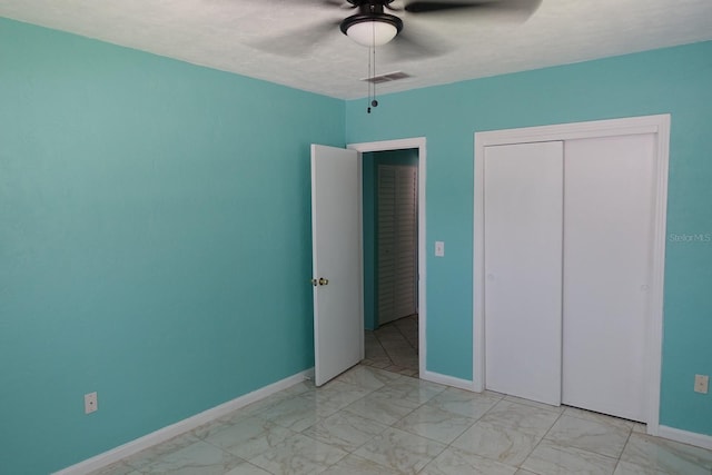 2810 SE Lake Weir Ave, Ocala, FL 34471 - unfurnished bedroom featuring light marble finish flooring, a closet, baseboards, and ceiling fan