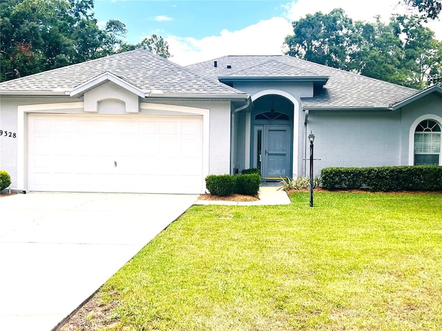 9328 SW 192nd Court Rd, Dunnellon, FL 34432 - ranch-style home featuring roof with shingles, an attached garage, a front yard, and driveway