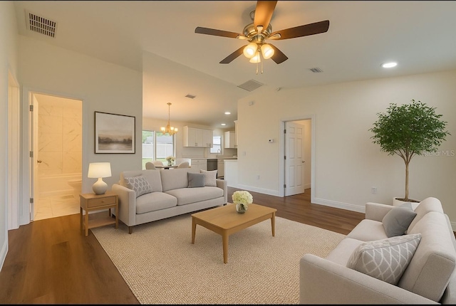 3527 SW 149th Ter, Ocala, FL 34481 - living room featuring dark wood-style flooring, a chandelier, ceiling fan, recessed lighting, and baseboards