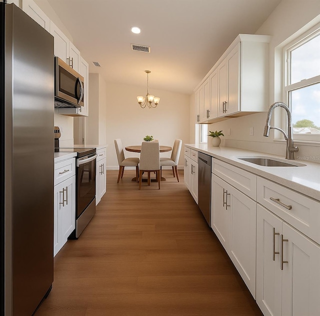 3527 SW 149th Ter, Ocala, FL 34481 - kitchen with appliances with stainless steel finishes, a sink, white cabinetry, recessed lighting, and dark wood-style flooring