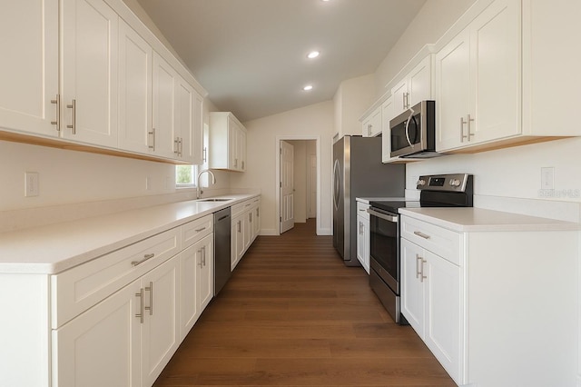 3527 SW 149th Ter, Ocala, FL 34481 - kitchen featuring stainless steel appliances, white cabinets, wood finished floors, recessed lighting, and vaulted ceiling