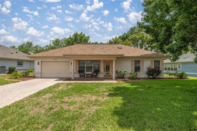 11326 SE 175th Pl, Summerfield, FL 34491 - ranch-style house with stucco siding, cooling unit, an attached garage, decorative driveway, and a front lawn