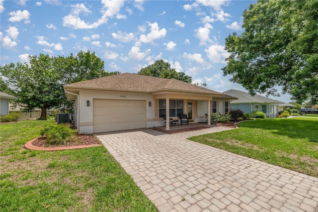 11326 SE 175th Pl, Summerfield, FL 34491 - single story home featuring decorative driveway, an attached garage, stucco siding, and a front lawn