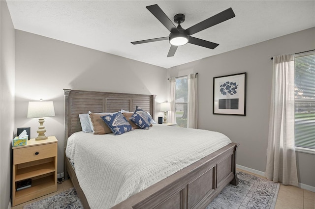 11326 SE 175th Pl, Summerfield, FL 34491 - bedroom with multiple windows, light tile patterned floors, ceiling fan, and baseboards