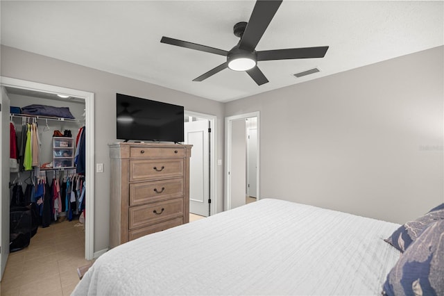 11326 SE 175th Pl, Summerfield, FL 34491 - bedroom featuring a walk in closet, a closet, light tile patterned floors, a ceiling fan, and baseboards