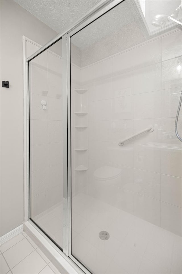 11326 SE 175th Pl, Summerfield, FL 34491 - bathroom featuring a shower stall, tile patterned flooring, and a textured ceiling